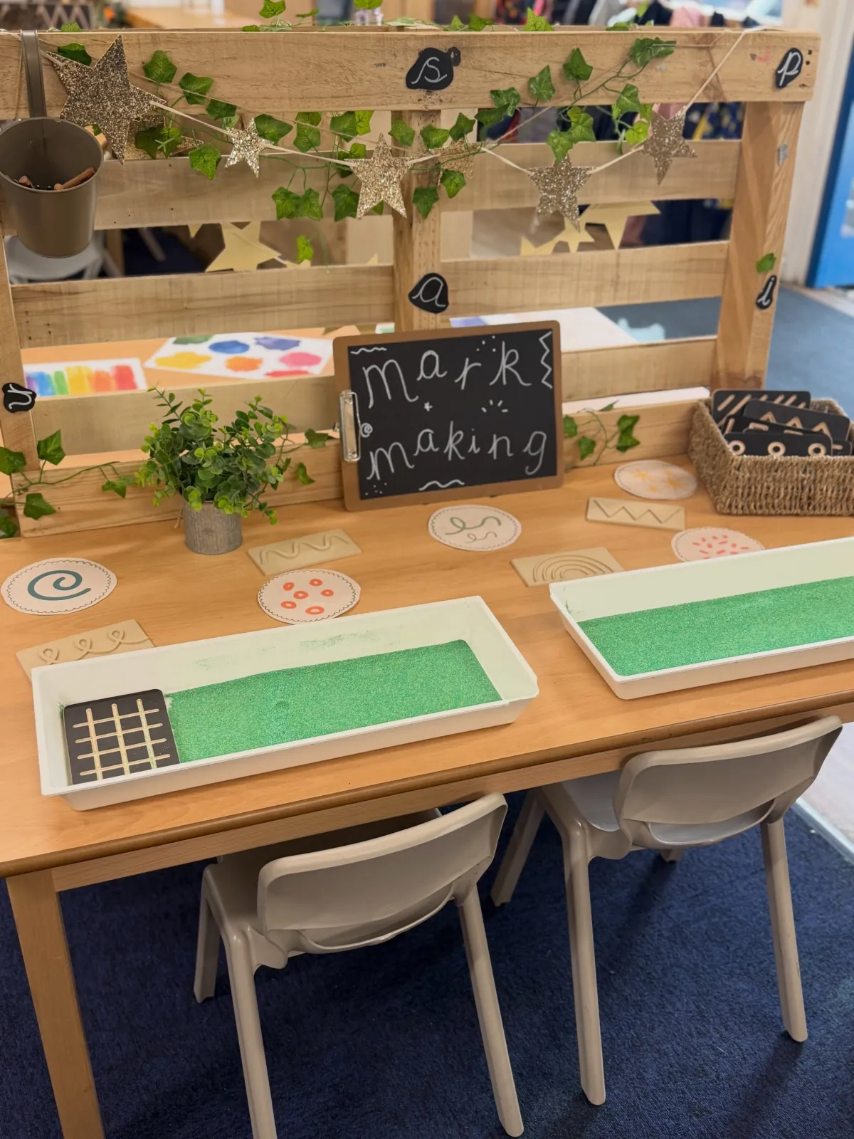 Laura's Reception classroom: wooden crates, woven baskets and a doll's cradle