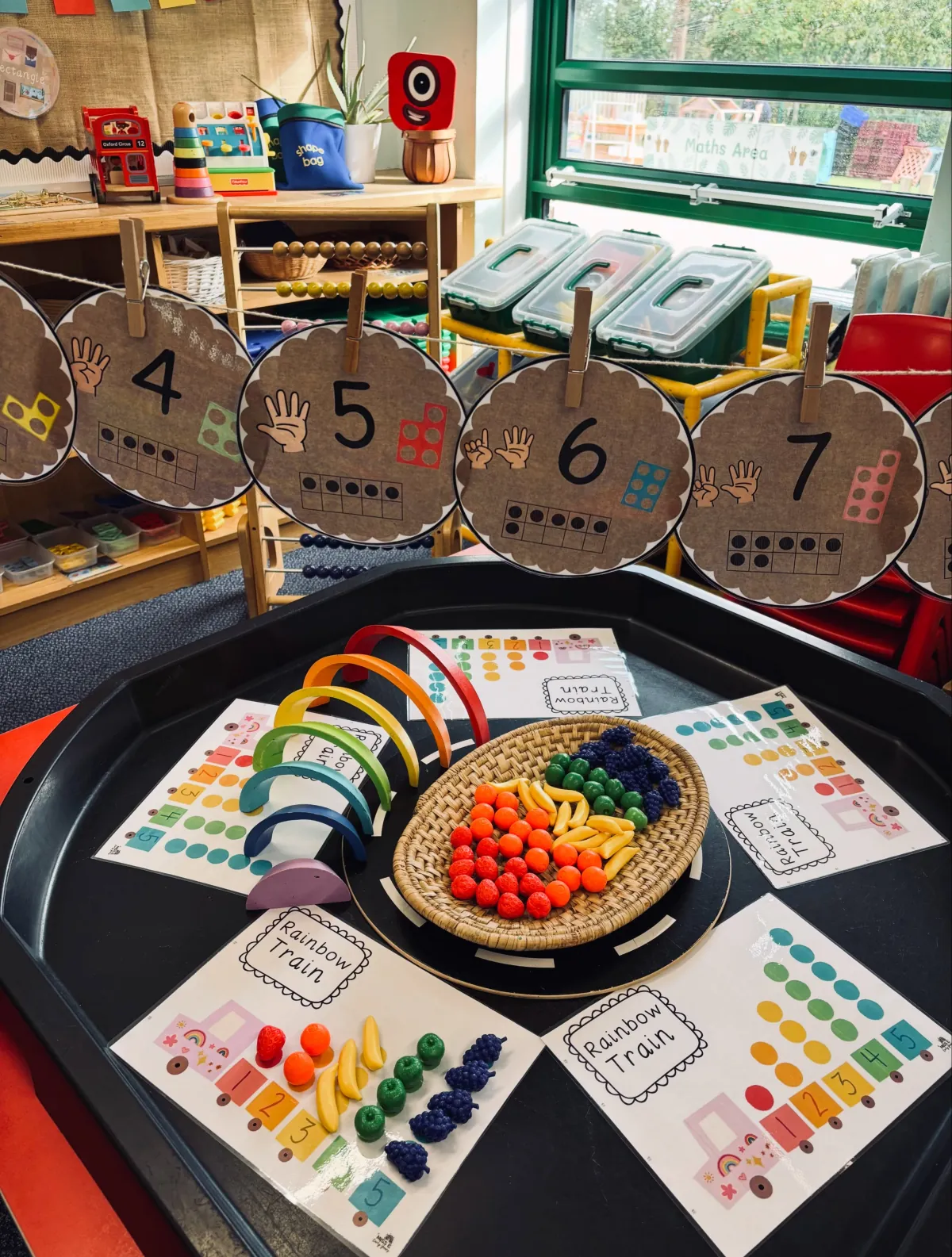 A mark-making area in Laura's classroom with wooden crates and ivy